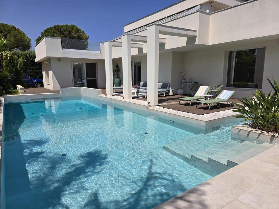 Property building, Patio, Pool view, Swimming pool, sunbed