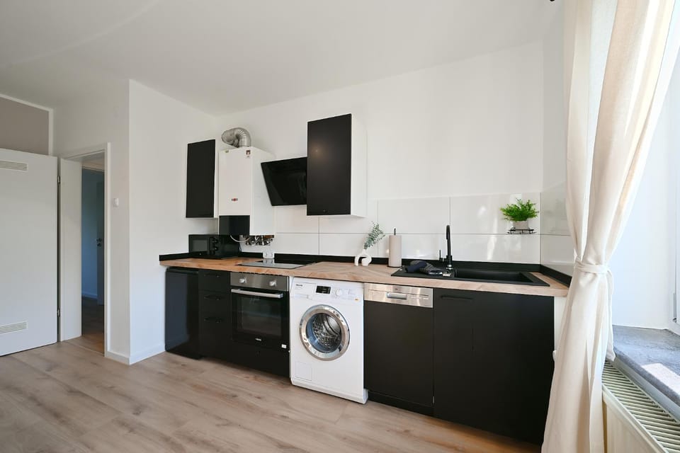 Kitchen or kitchenette, dishwasher, oven, stove, washing machine