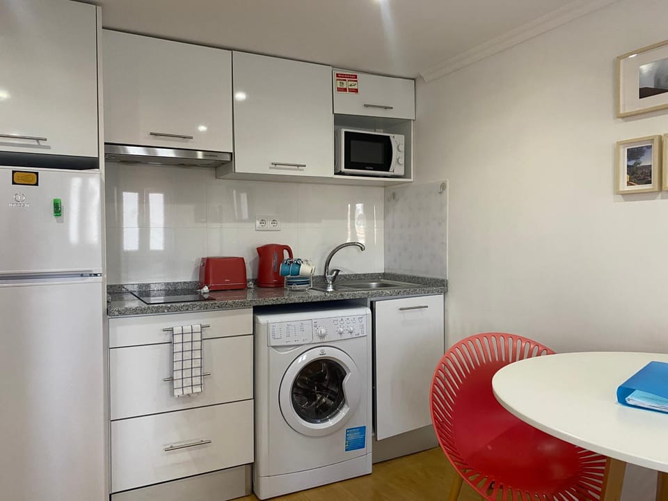 Kitchen or kitchenette, oven, stove, toaster, washing machine