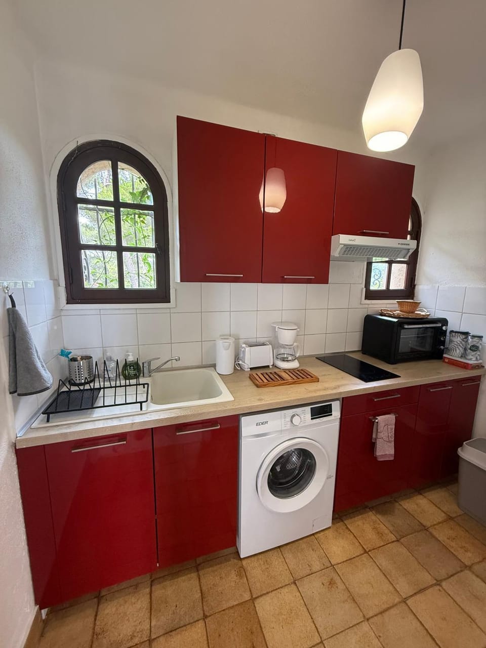Kitchen or kitchenette, stove, toaster, washing machine