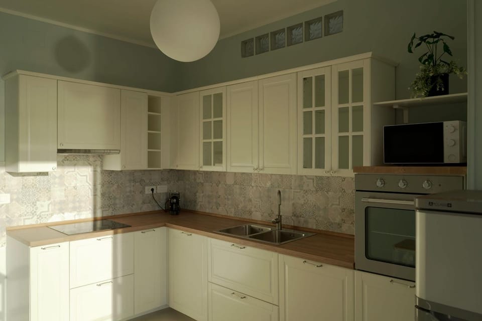 Photo of the whole room, microwave, oven, kitchen