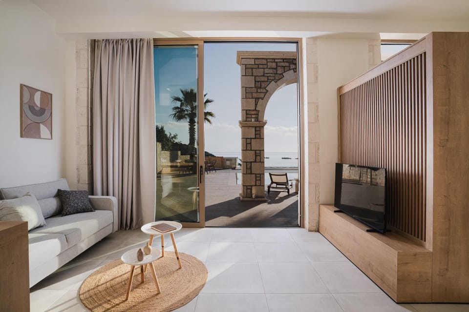 Bed, Natural landscape, TV and multimedia, Living room, Seating area, Sea view