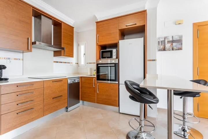 Kitchen or kitchenette, dishwasher, oven, stove