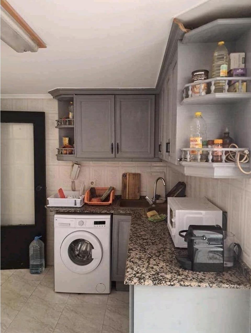 Kitchen or kitchenette, oven, stove, washing machine