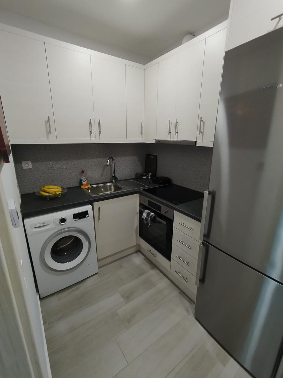 Kitchen or kitchenette, oven, stove, toaster, washing machine