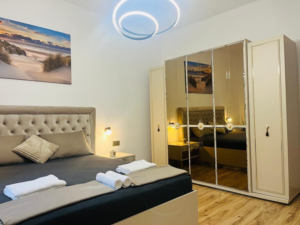 Bed, TV and multimedia, Seating area, Bedroom, towels, wardrobe