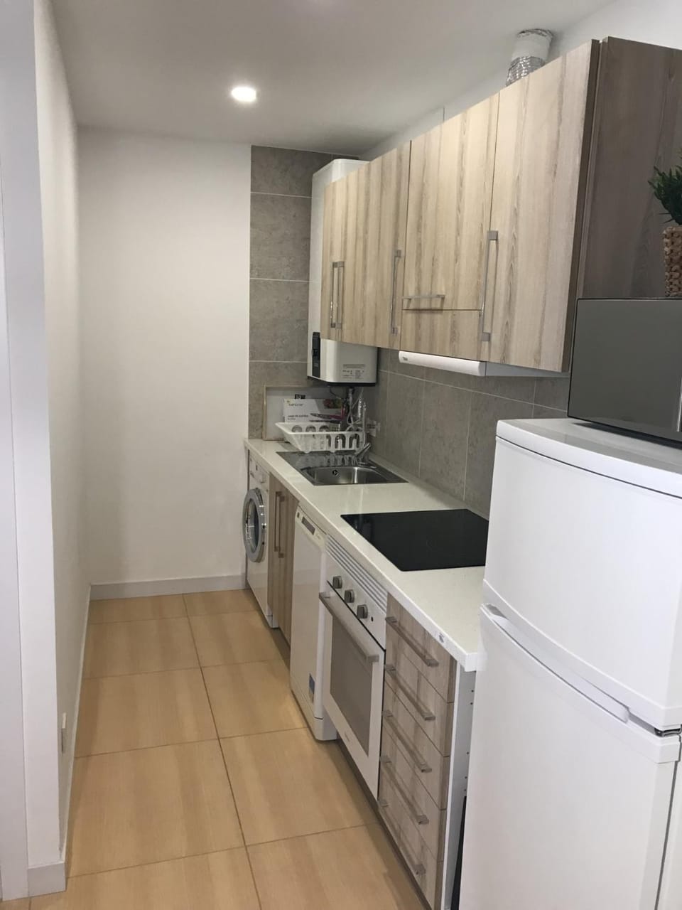 Kitchen or kitchenette, dishwasher, oven, stove