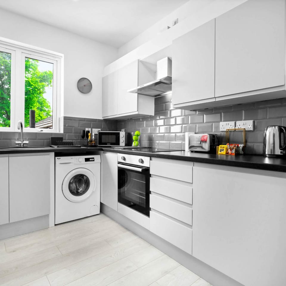 Kitchen or kitchenette, oven, stove, toaster, washing machine