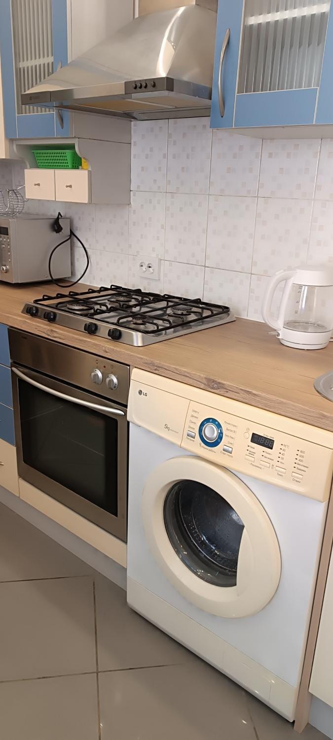 Kitchen or kitchenette, stove, washing machine