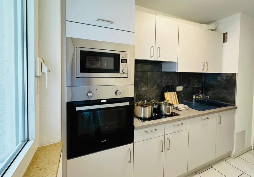 Kitchen or kitchenette, dishwasher, microwave, oven