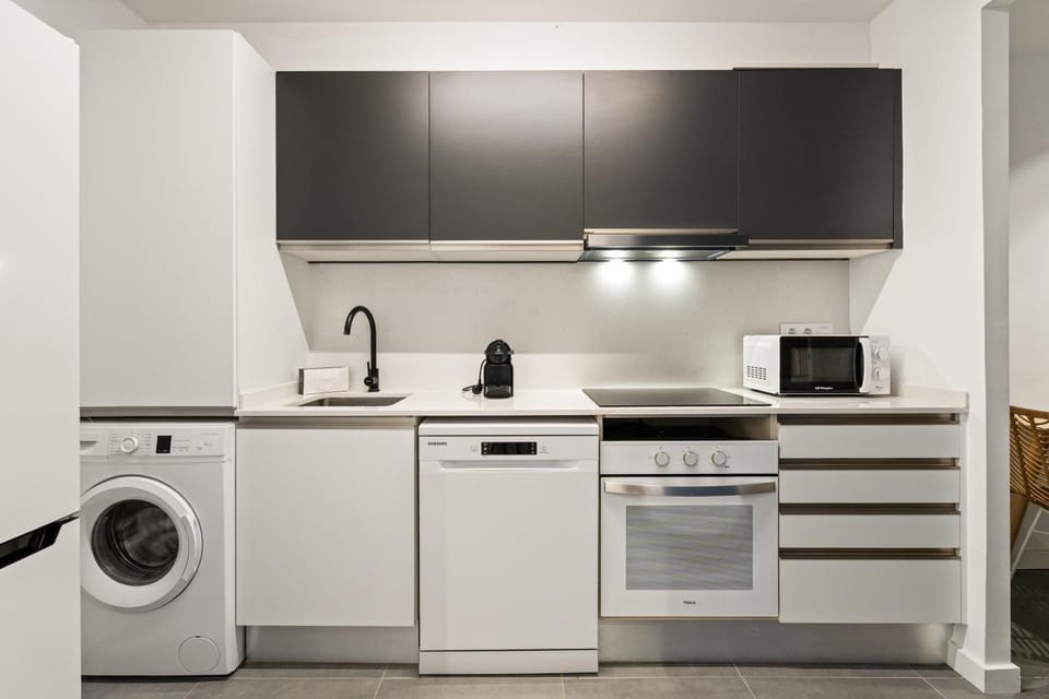 Kitchen or kitchenette, dishwasher, oven, stove, washing machine