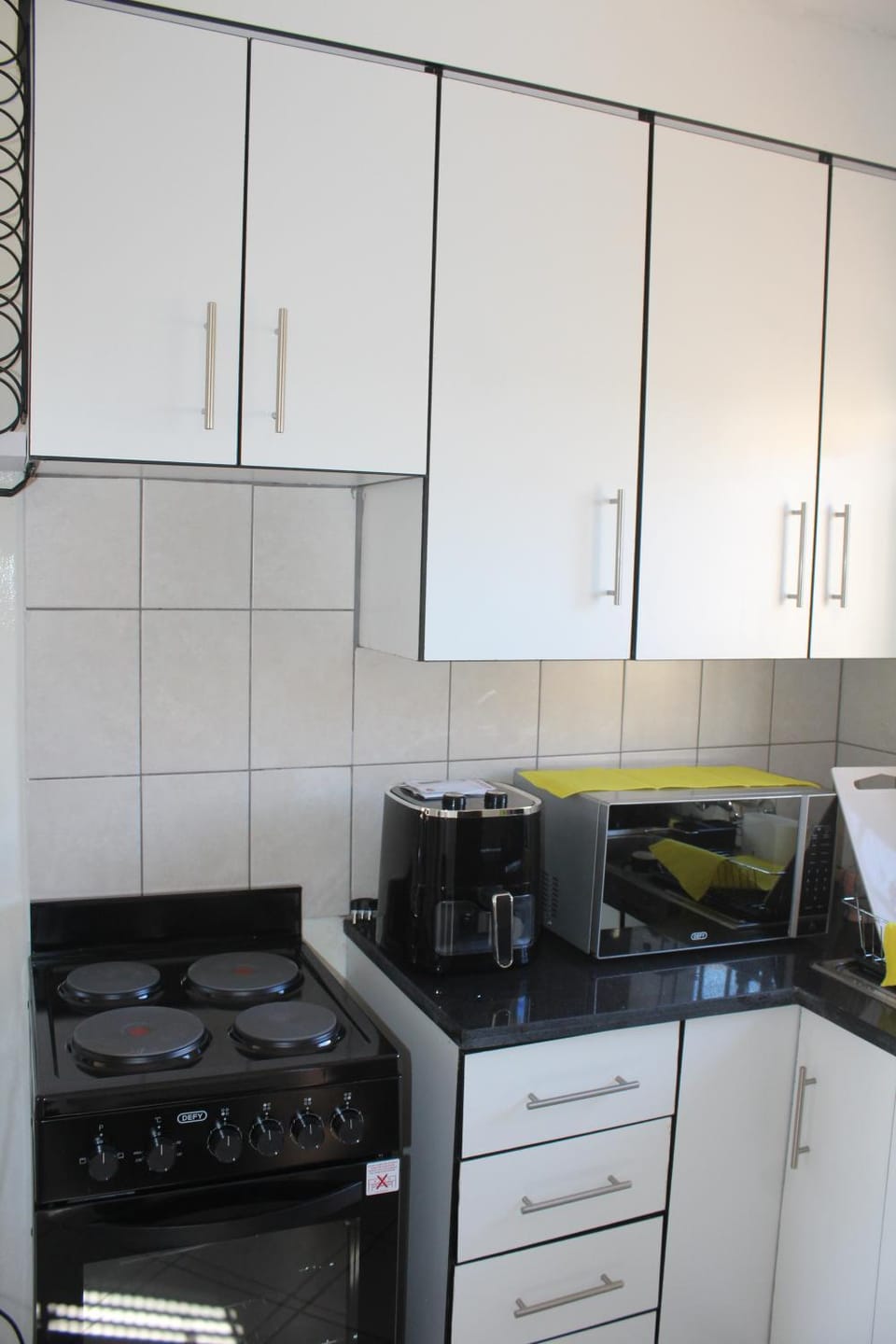 Kitchen or kitchenette, microwave, stove, toaster