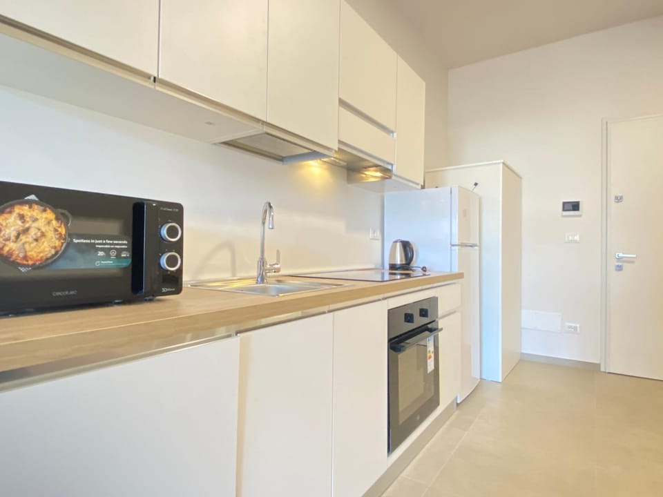 Kitchen or kitchenette, dishwasher, oven, stove