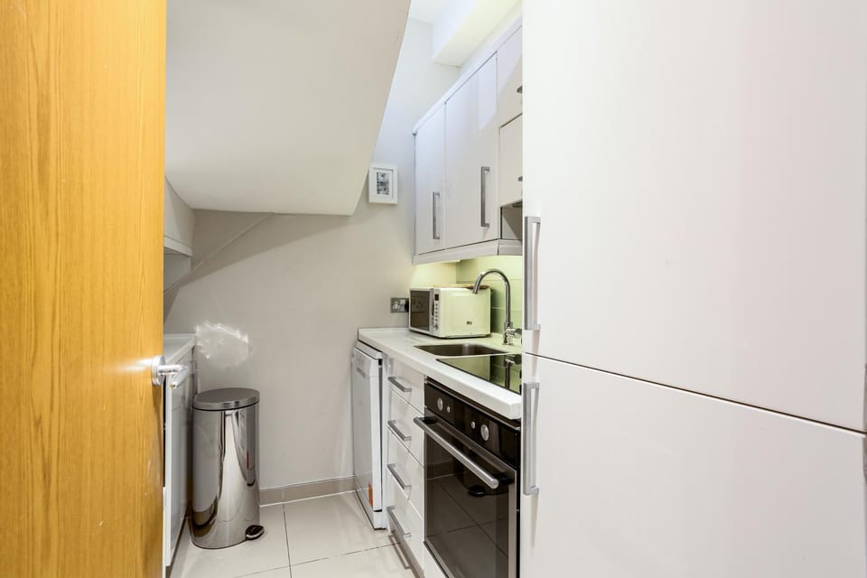 Kitchen or kitchenette, dishwasher, oven, stove
