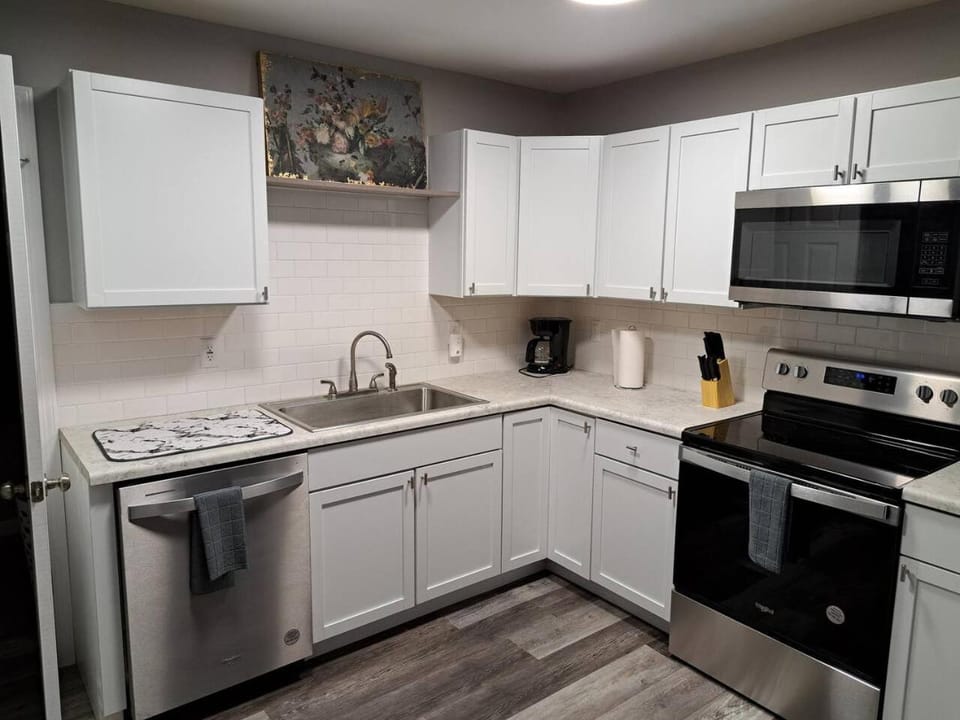 Kitchen or kitchenette, dishwasher, oven, stove