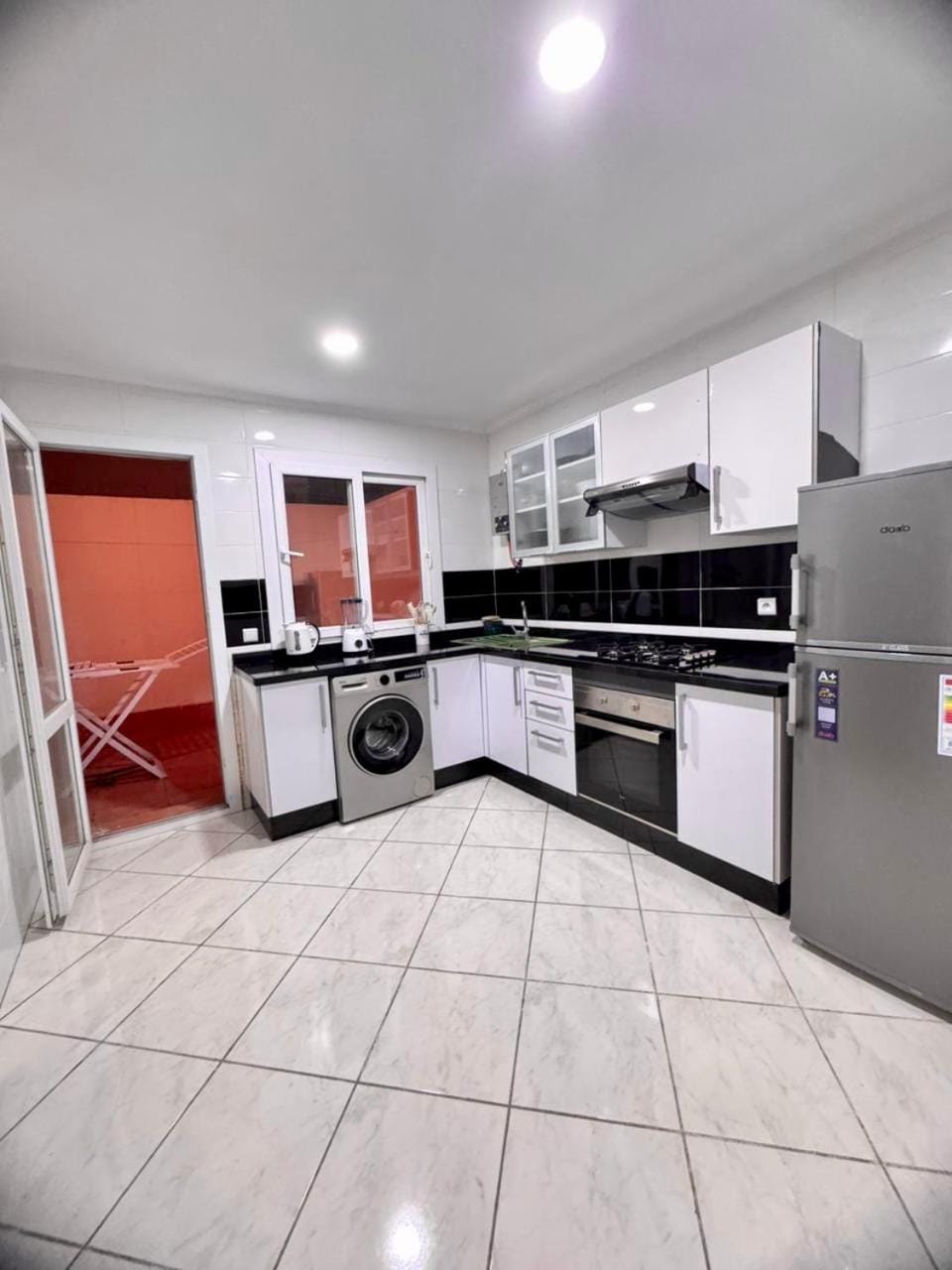 Kitchen or kitchenette, oven, stove, washing machine