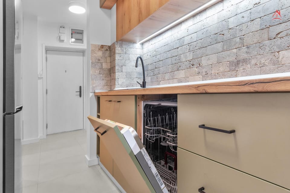 Kitchen or kitchenette, dishwasher, oven, stove