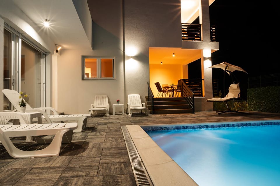 Patio, Night, Seating area, Pool view, Swimming pool