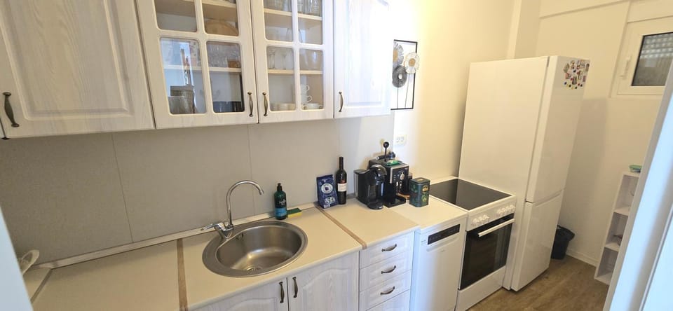 Kitchen or kitchenette, dishwasher, oven, stove