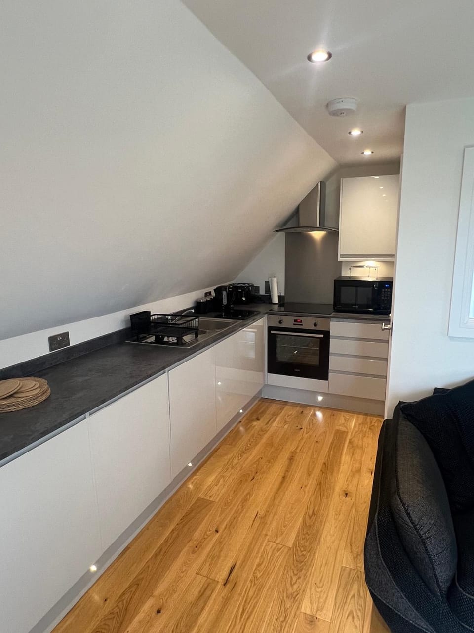 Kitchen or kitchenette, dishwasher, microwave, oven, stove, toaster, washing machine