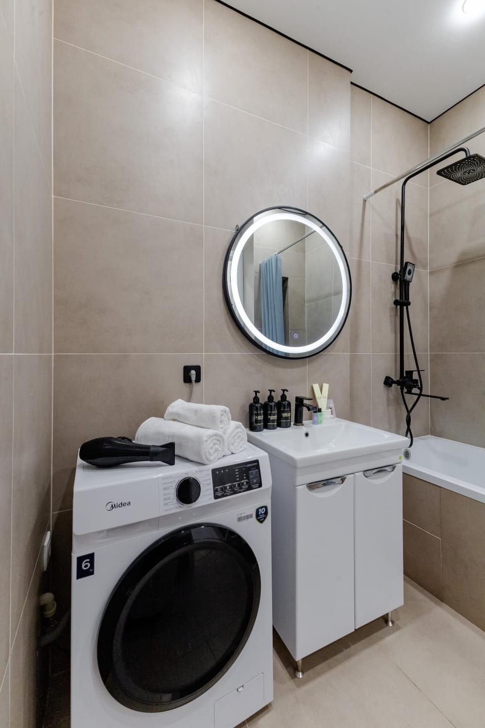Bathroom, hair dryier, towels, washing machine