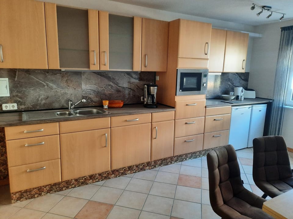 Kitchen or kitchenette, dishwasher, microwave, oven, stove, toaster