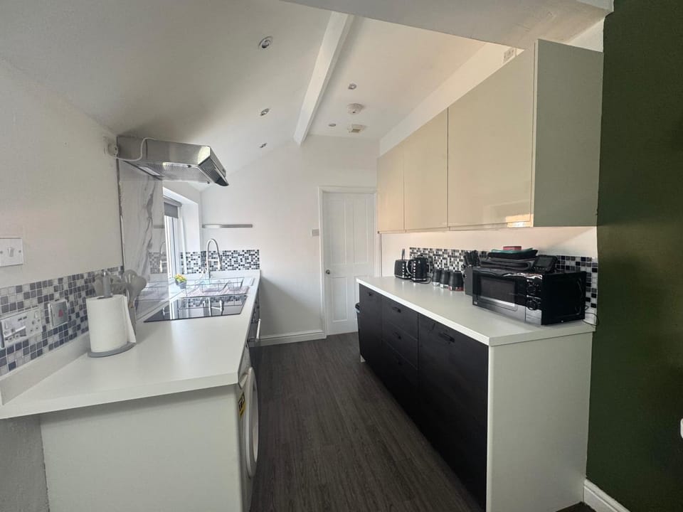 Kitchen or kitchenette, microwave, stove, toaster