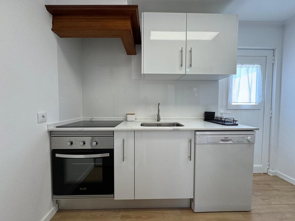 Kitchen or kitchenette, dishwasher, oven, stove