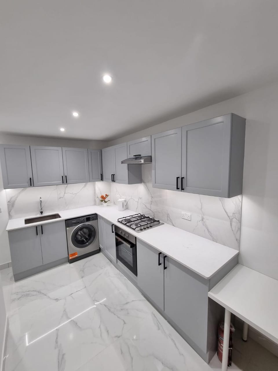 Kitchen or kitchenette, microwave, oven, stove, washing machine