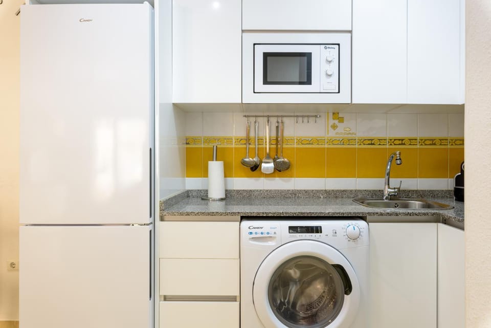 Kitchen or kitchenette, microwave, stove, washing machine