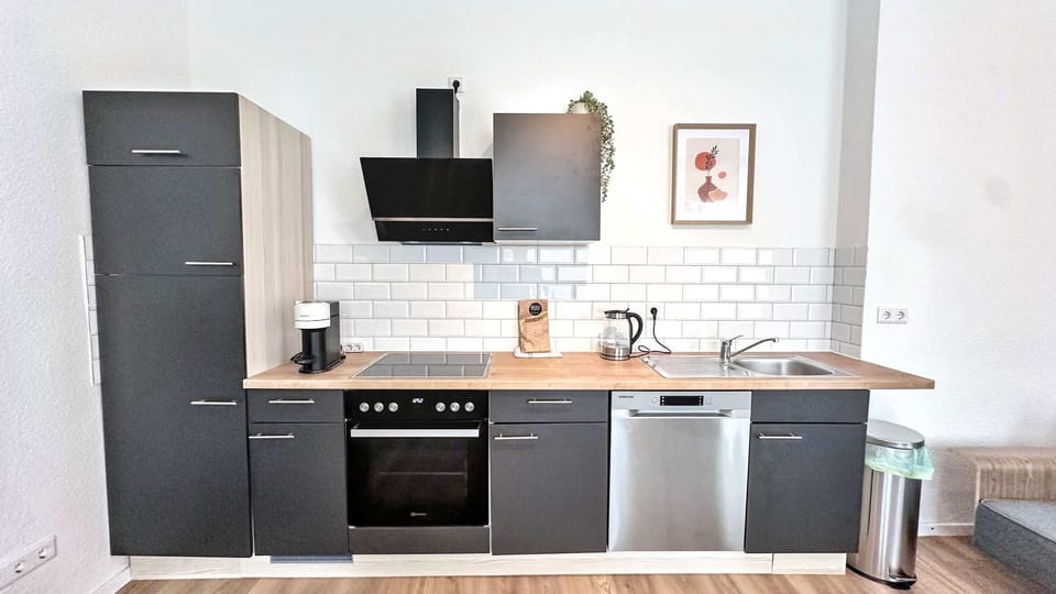 Kitchen or kitchenette, dishwasher, oven, stove
