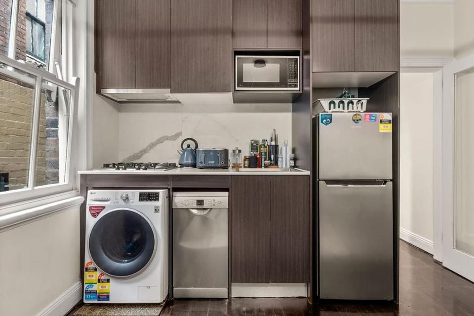 Kitchen or kitchenette, microwave, stove, washing machine