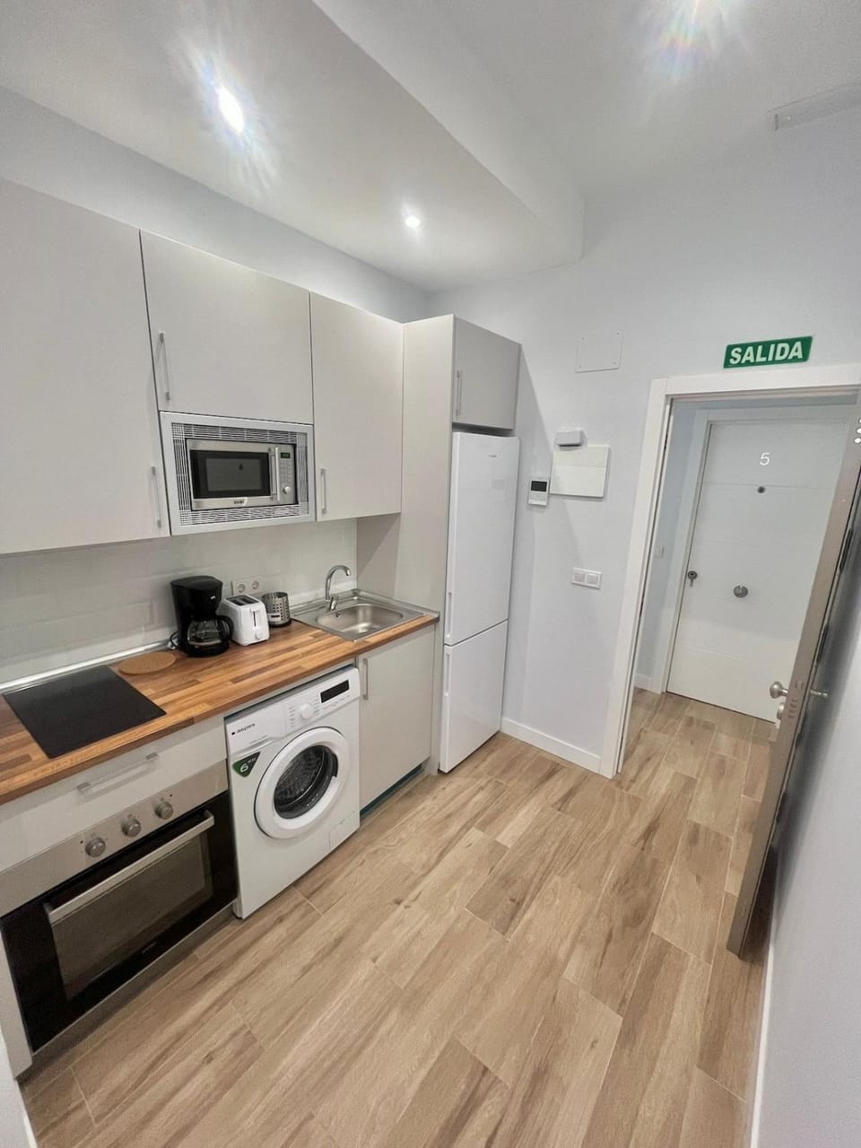 Kitchen or kitchenette, oven, stove, washing machine