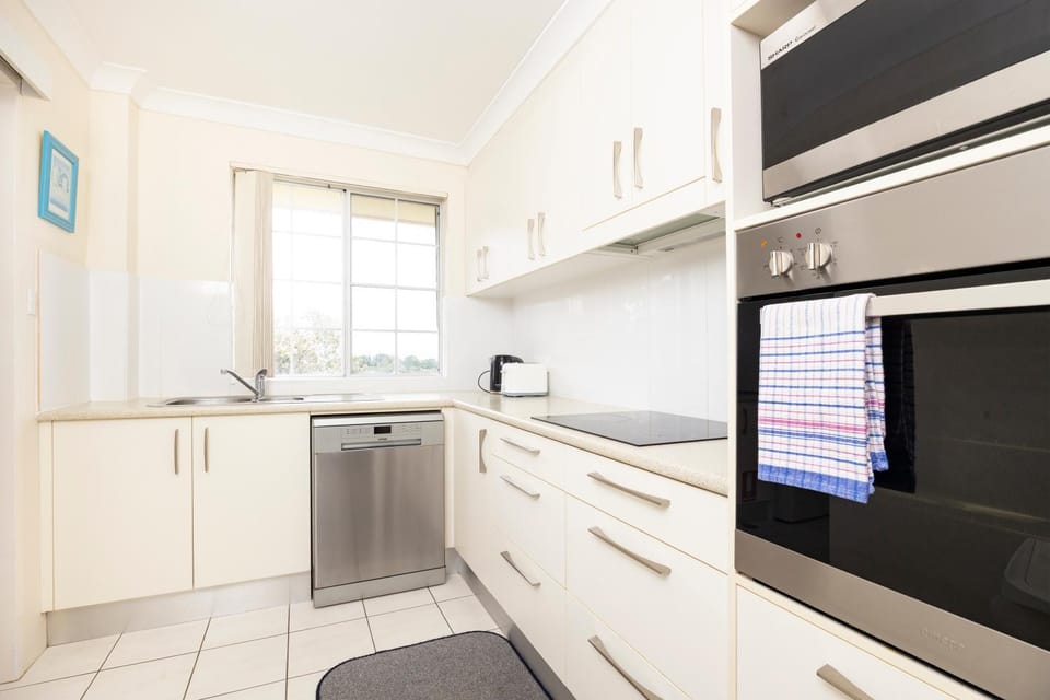 Kitchen or kitchenette, dishwasher, oven, stove