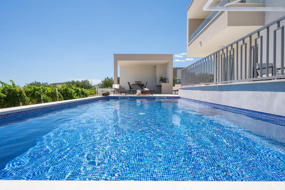 Property building, Patio, Day, Pool view, sunbed