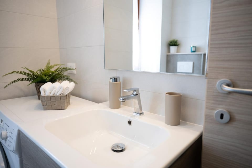 Bathroom, hair dryier, towels, washing machine