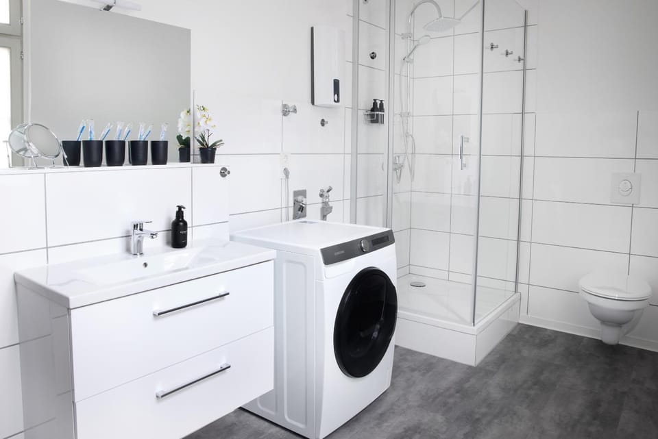 Shower, Toilet, Bathroom, hair dryier, towels, washing machine, dryer