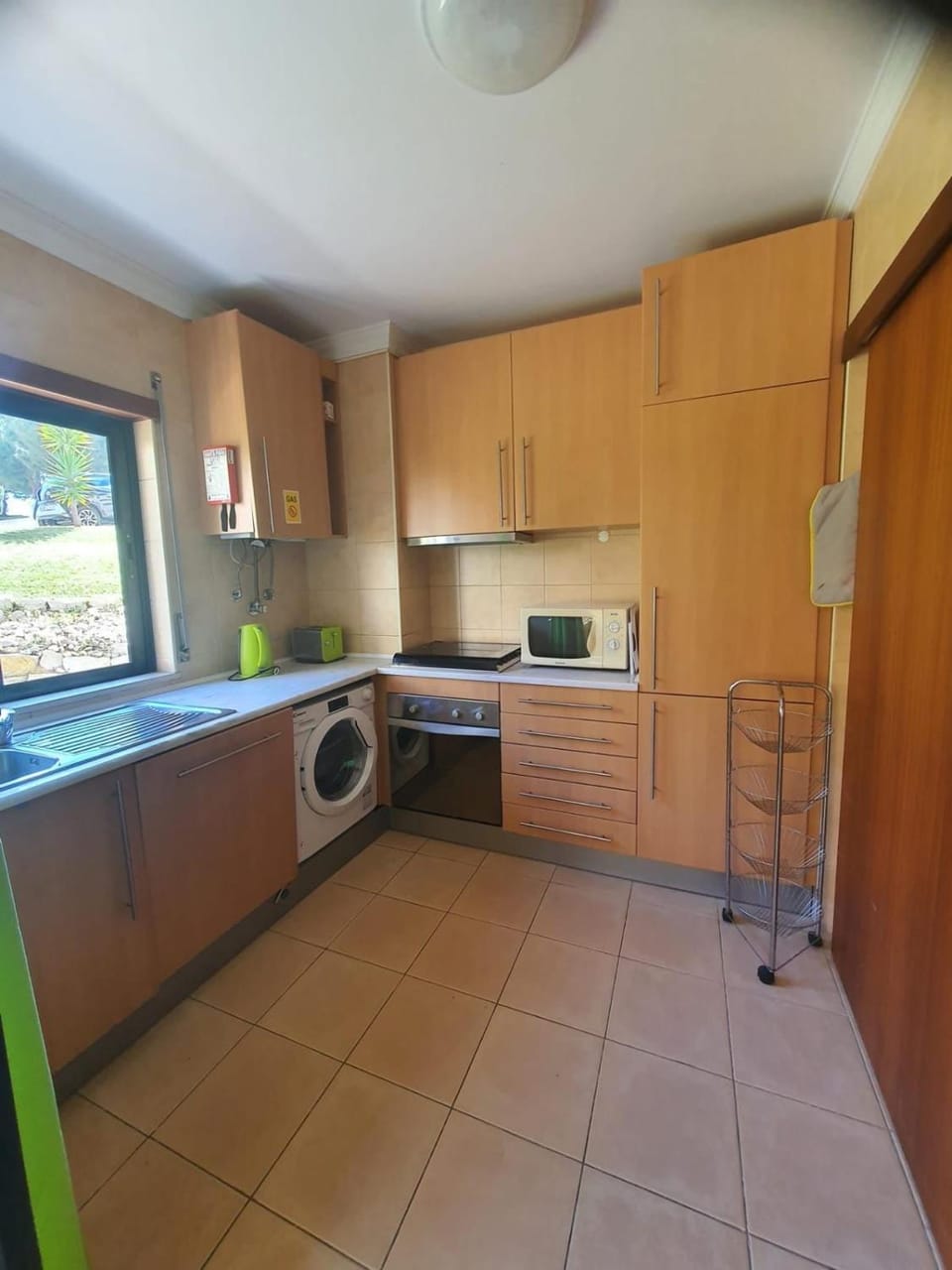Kitchen or kitchenette, microwave, stove, toaster, washing machine