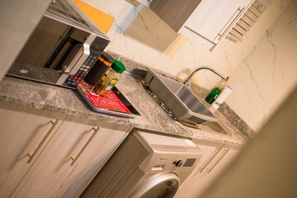 Kitchen or kitchenette, microwave, washing machine, dryer