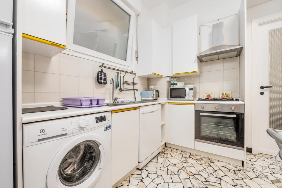 Kitchen or kitchenette, dishwasher, microwave, oven, stove, toaster, washing machine