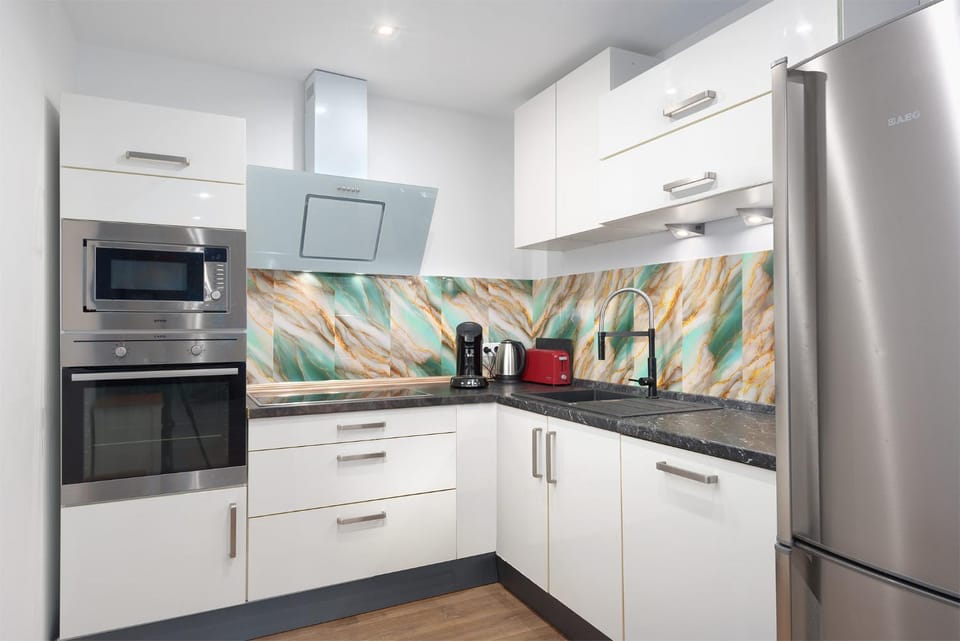 Kitchen or kitchenette, dishwasher, oven, stove, toaster