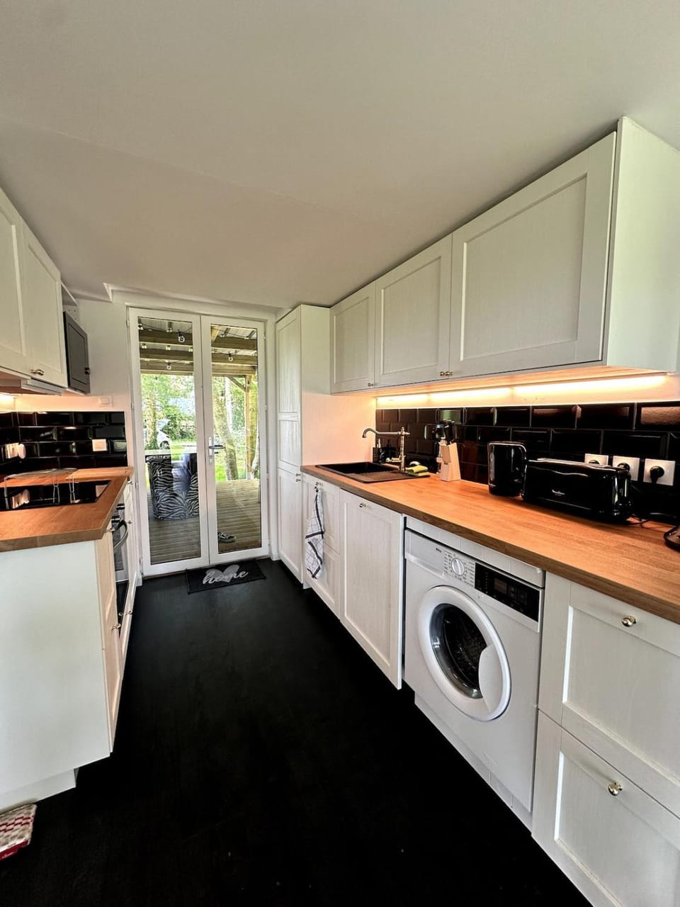 Kitchen or kitchenette, dishwasher, oven, stove, toaster, washing machine, dryer