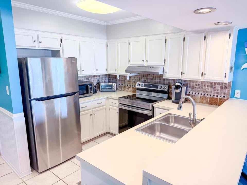 Kitchen or kitchenette, dishwasher, oven, stove, toaster