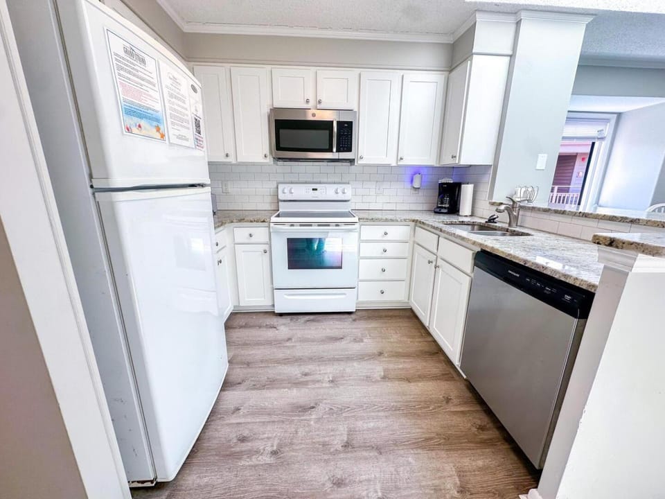 Kitchen or kitchenette, dishwasher, oven, stove