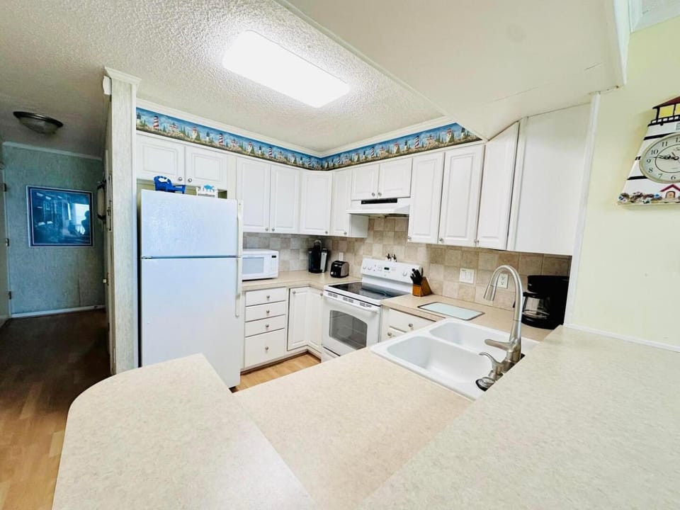 Kitchen or kitchenette, dishwasher, oven, stove, toaster