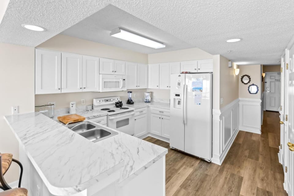 Kitchen or kitchenette, dishwasher, oven, stove