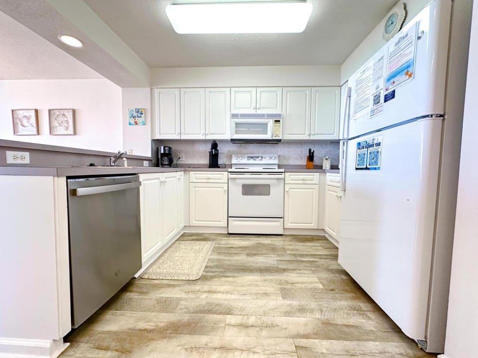 Kitchen or kitchenette, dishwasher, oven, stove