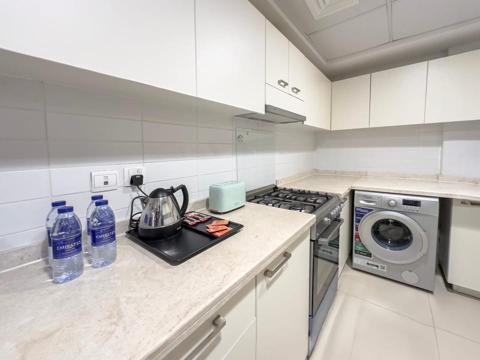 Kitchen or kitchenette, stove, toaster, washing machine