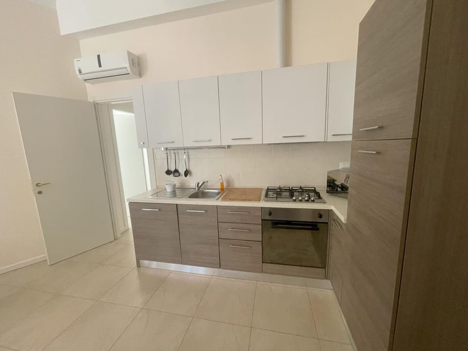 Kitchen or kitchenette, dishwasher, oven, stove
