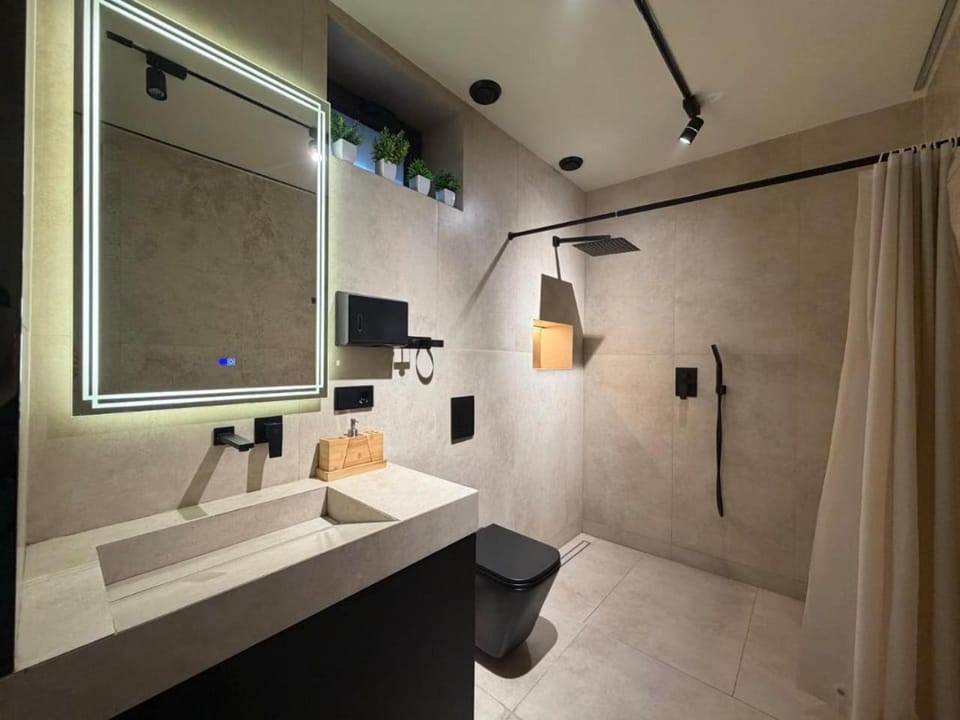 Shower, Toilet, Bathroom, Bath, bidet, hair dryier, towels, washing machine, dryer